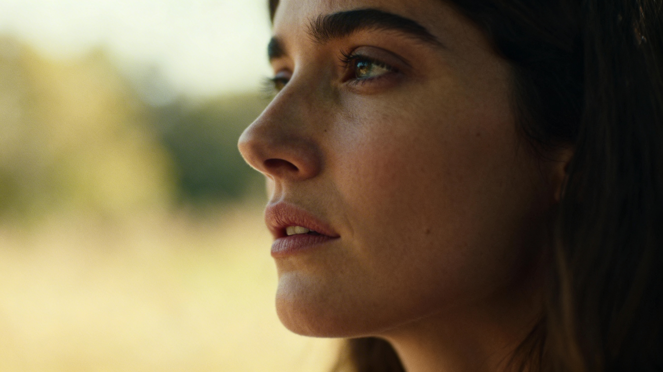 Close-up of woman's face looking unfocused, struggling to concentrate