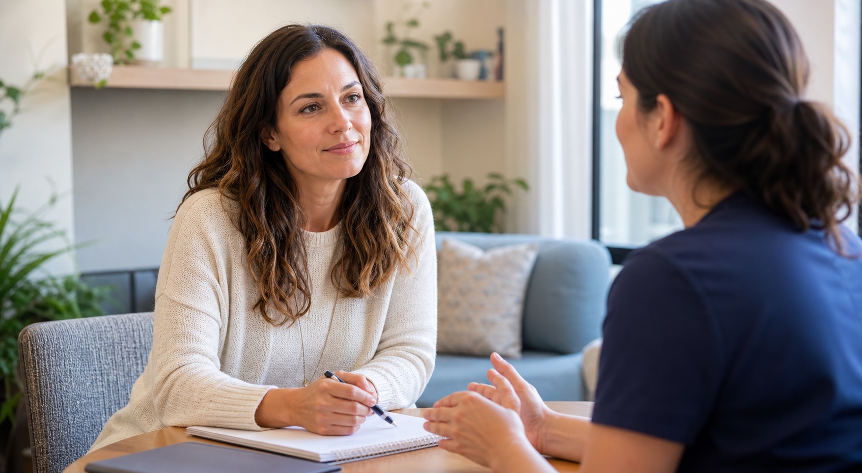 Woman calmly discussing symptom notes with a healthcare provider