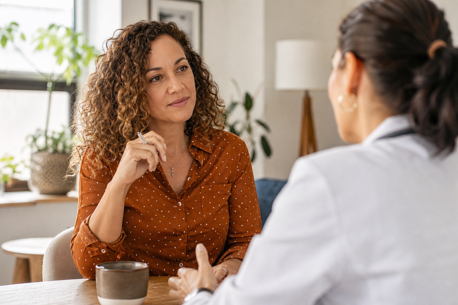 Woman discussing persistent itchy skin and perimenopause symptoms with a healthcare provider