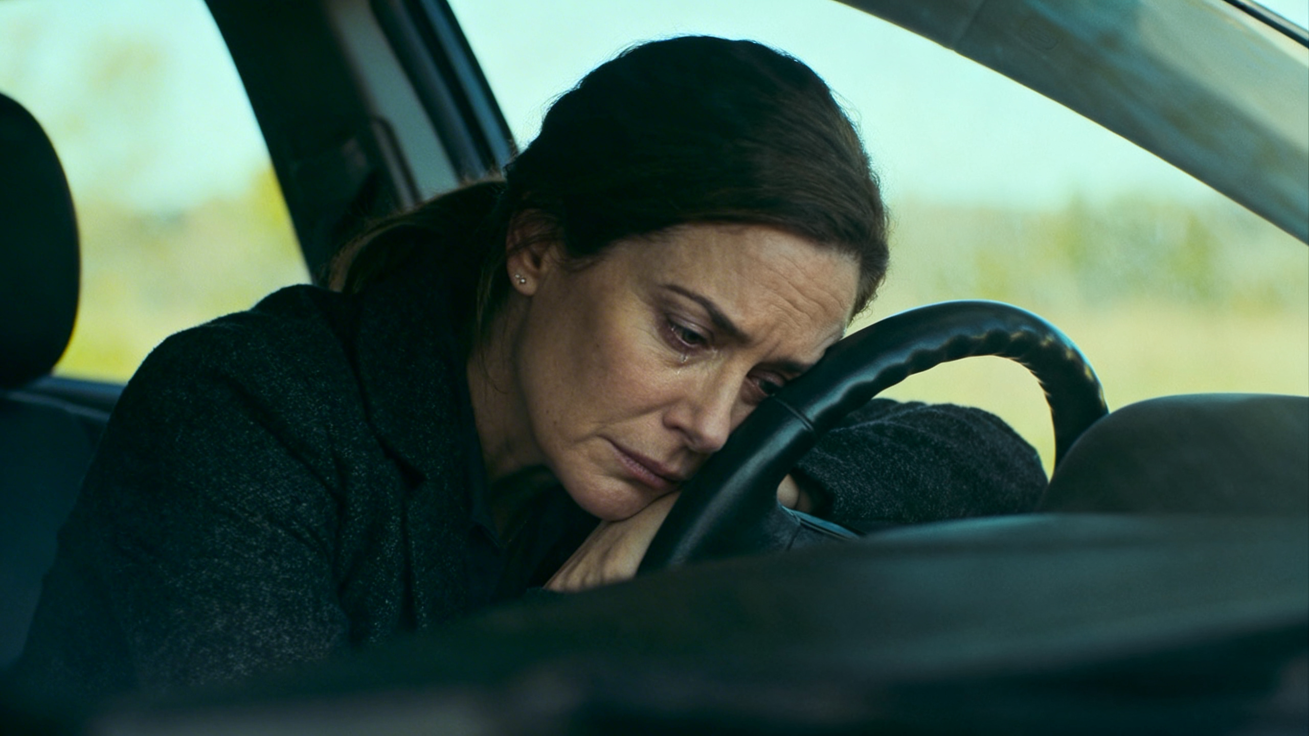 Woman sitting in her car after a doctor's appointment